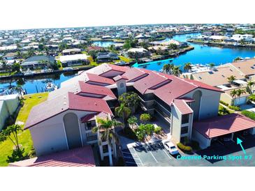 Aerial view of condo community, showing building, pool, and boat docks at 2601 W Marion Ave # 45C, Punta Gorda, FL 33950