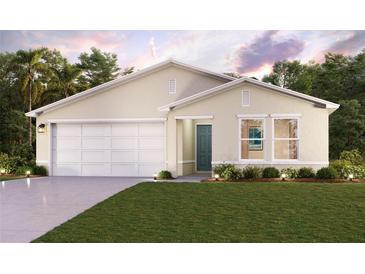 Tan house with a two-car garage, landscaping, and a teal front door at 27093 N Twin Lakes Dr, Punta Gorda, FL 33955