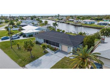 Aerial view of canal-front home with large backyard and carport at 312 E Tarpon Nw Blvd, Port Charlotte, FL 33952