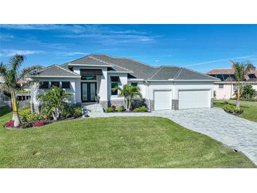 Stunning curb appeal with gray roof, landscaping, and two-car garage at 3307 Dominica Ct, Punta Gorda, FL 33950