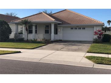 One-story home with tile roof, attached garage, and manicured lawn at 6379 Grand Cypress Blvd, North Port, FL 34287