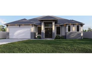 Modern house with gray roof and stone accents at 12 Ebb Cir, Placida, FL 33946