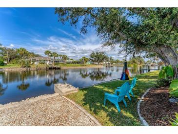 Relaxing waterfront backyard features seating area and canal views at 18390 Burkholder Cir, Port Charlotte, FL 33948