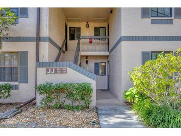 Exterior view of building with landscaping and parking at 19505 Quesada Ave # Jj101, Port Charlotte, FL 33948