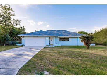 Charming single-story home with a well-maintained lawn at 2455 Pellam Blvd, Port Charlotte, FL 33948