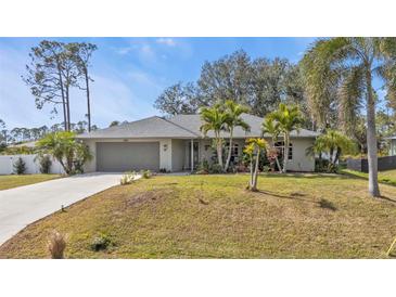 Single-story home with attached garage and landscaped lawn at 3189 Tally Ho Rd, North Port, FL 34291