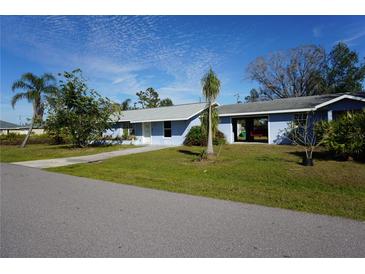 Ranch-style home with carport and mature landscaping at 422 Omen St, Punta Gorda, FL 33982