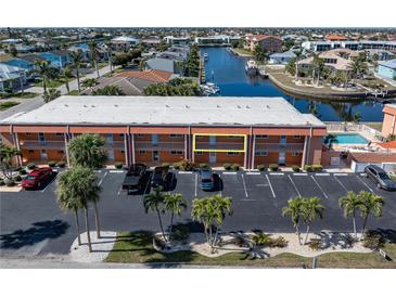 Aerial view of waterfront condo community with pool and parking at 1345 Mediterranean Dr # A204, Punta Gorda, FL 33950