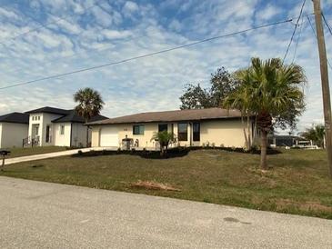 Single-story home with a well-maintained lawn and landscaping at 18938 Ayrshire Cir, Port Charlotte, FL 33948