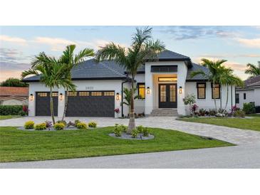 Stunning curb appeal! This home features a modern design, 2-car garage, and lush landscaping at 3800 Carupano Ct, Punta Gorda, FL 33950