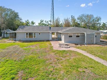 Charming single-story home with a walkway and a well-maintained lawn at 425 Fireball Ct, Punta Gorda, FL 33950
