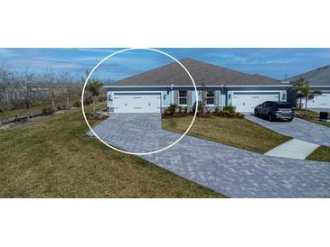 Two-car garage with paver driveway, offering ample parking and convenient access at 16255 Lady Palm Dr, Port Charlotte, FL 33953