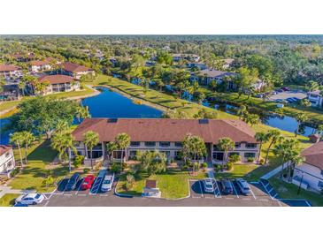 Beautiful aerial view of a condo building surrounded by lush landscaping and a tranquil waterway at 19505 Quesada Ave # O104, Port Charlotte, FL 33948