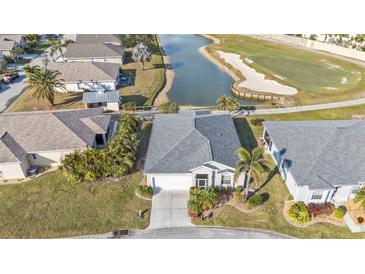 Aerial view of single-story home with golf course and lake views at 24904 Drumblaire Ct, Port Charlotte, FL 33980