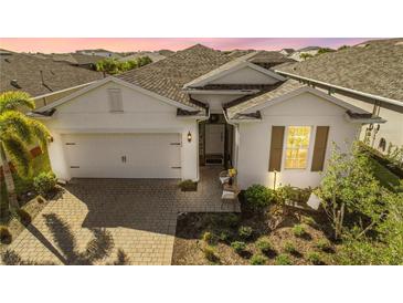 White two-story house with a two-car garage and landscaped yard at 43104 Lakeside Way, Punta Gorda, FL 33982