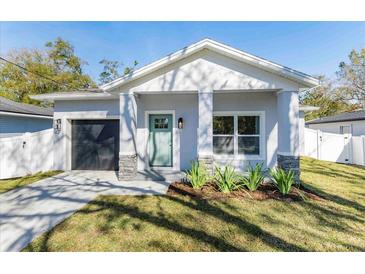 Charming craftsman style home with a teal door and stone accents at 706 W Madison St, Plant City, FL 33563