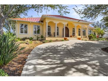 Beautiful one-story home with a circular driveway and lush landscaping at 21370 Harborside Blvd, Port Charlotte, FL 33952