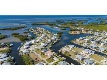 Aerial view of waterfront home with private dock and boat lift at 24248 Treasure Island Blvd, Punta Gorda, FL 33955