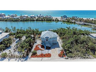 Beautiful coastal home features lush landscaping, water access and serene views of bay and ocean at 37 Bocilla Dr, Placida, FL 33946