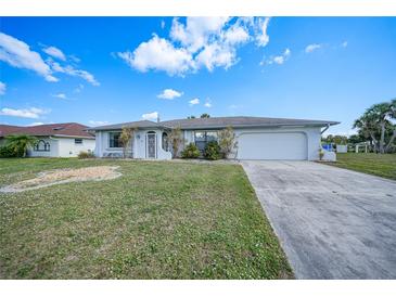 Single-story house with a spacious yard and driveway at 4415 Mundella Cir, Port Charlotte, FL 33948