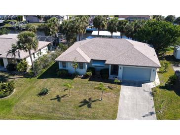 Well-maintained single Gathering home with a two car garage and beautifully manicured lawn with mature landscaping at 4542 Fallon Cir, Port Charlotte, FL 33948