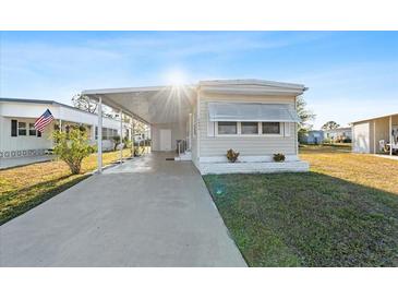 Charming single-story home featuring a long driveway and covered parking area at 6835 Anapa Ct, North Port, FL 34287