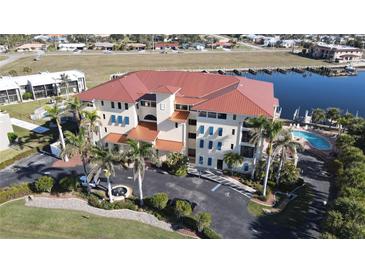 Stunning waterfront condo with a pool, lush landscaping, and convenient parking at 1340 Rock Dove Ct # 143, Punta Gorda, FL 33950