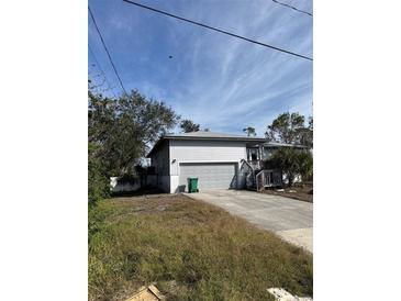 Single story home with an attached garage and driveway at 8152 Robert St, Englewood, FL 34224