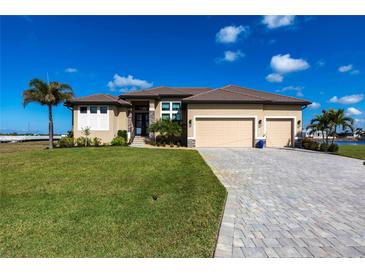 Beautiful single Gathering home with a well-manicured lawn, palm trees, and paved driveway leading to a three car garage at 17122 Barcrest Ln, Punta Gorda, FL 33955