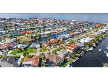 Waterfront home featuring canal access, lush landscaping, and a tranquil neighborhood setting at 2284 Palm Tree Dr, Punta Gorda, FL 33950