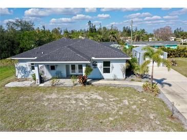 Charming single-story home with a well-manicured front yard and a cozy, inviting porch area at 3714 Gulfbreeze Ln, Punta Gorda, FL 33950