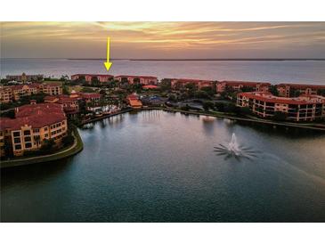 Stunning aerial view of a waterfront community with a large lake and beautiful sunset scenery at 93 Vivante Blvd # 9336, Punta Gorda, FL 33950