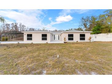 Charming single-story home with a well-maintained front yard and bright white exterior at 9505 Delray Dr, New Port Richey, FL 34654