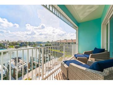 Relax on this spacious balcony with plush seating and serene water views at 11723 1St E St, Treasure Island, FL 33706