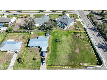 Aerial view of property including neighboring structures and property line highlighted in yellow at 3120 Wisteria Pl, Punta Gorda, FL 33950