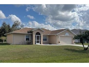 Charming single-story home featuring a manicured lawn and attached two-car garage at 376 Vitorio St, Punta Gorda, FL 33983