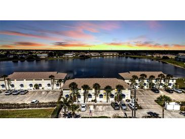 Beautiful aerial view of condos with lake view at sunset at 26300 Rampart Blvd # 404, Punta Gorda, FL 33983
