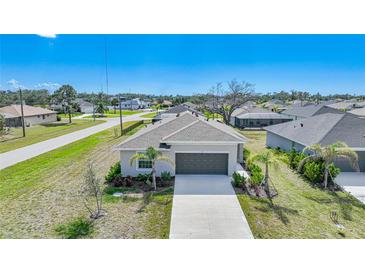 Well-maintained single-story home featuring a two-car garage and a beautifully landscaped front yard at 149 Hercules Dr, Rotonda West, FL 33947