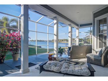 Relaxing screened porch with comfortable seating and stunning water views at 435 Manns Harbor Dr, Apollo Beach, FL 33572