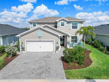 Charming two-story home with a brick driveway, manicured lawn, and delightful turquoise shutters at 43554 Treadway Dr, Punta Gorda, FL 33982