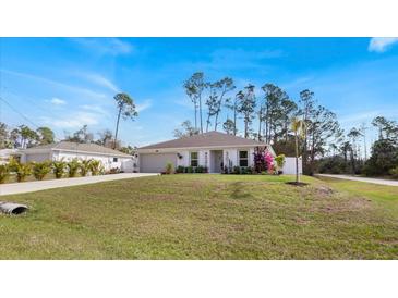 Charming single-story home featuring a well-manicured lawn and inviting curb appeal at 4980 Dakota Ter, North Port, FL 34286