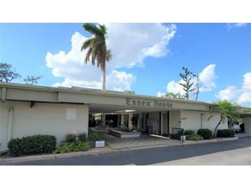 Essex House building exterior, featuring landscaping and parking at 2437 Harbor Blvd # 219, Port Charlotte, FL 33952