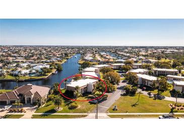 Aerial view of waterfront property with canal access and lush landscaping at 1080 Bal Harbor Blvd # 1C, Punta Gorda, FL 33950