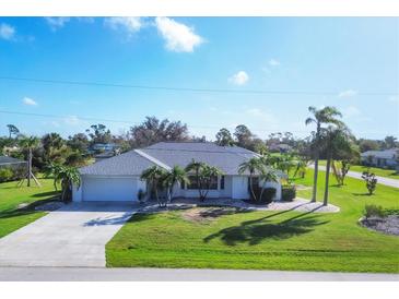 Single-story home with a spacious yard and palm trees at 78 Lima St, Punta Gorda, FL 33983