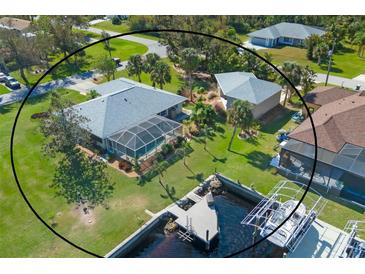 Aerial view of canal front home with private dock and pool at 5105 Ackley Ter, Port Charlotte, FL 33981