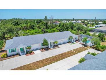 Aerial view of three-unit property with private pool and ample parking at 268 Rotonda W Blvd # 1B, Rotonda West, FL 33947