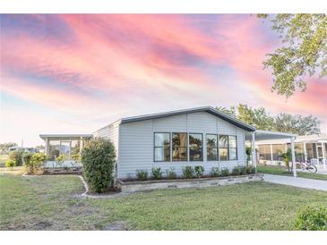 Charming single-story home with well-maintained landscaping and covered parking at 6113 Partridge Ave, Englewood, FL 34224