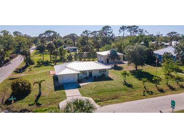 Aerial view of a single-story house with a metal roof and large backyard at 445 Stewart St, Englewood, FL 34223