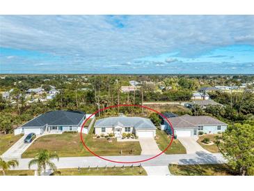 Aerial view of single-story house with attached garage and yard at 10430 Chablis Ave, Englewood, FL 34224