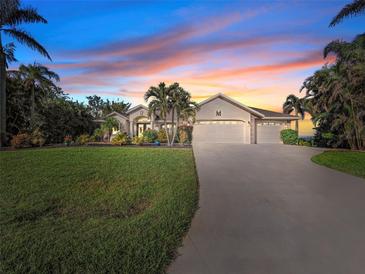 Beautiful home with landscaped yard and three-car garage at 15375 Taurus Cir, Port Charlotte, FL 33981